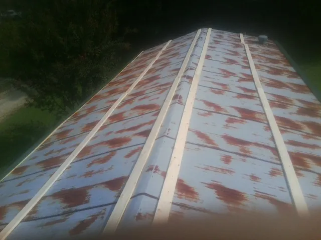 Rusted metal roof panels with new wood purlins before replacement — Storm Damage Roof Repair in Croton On Hudson by Roofing Brothers